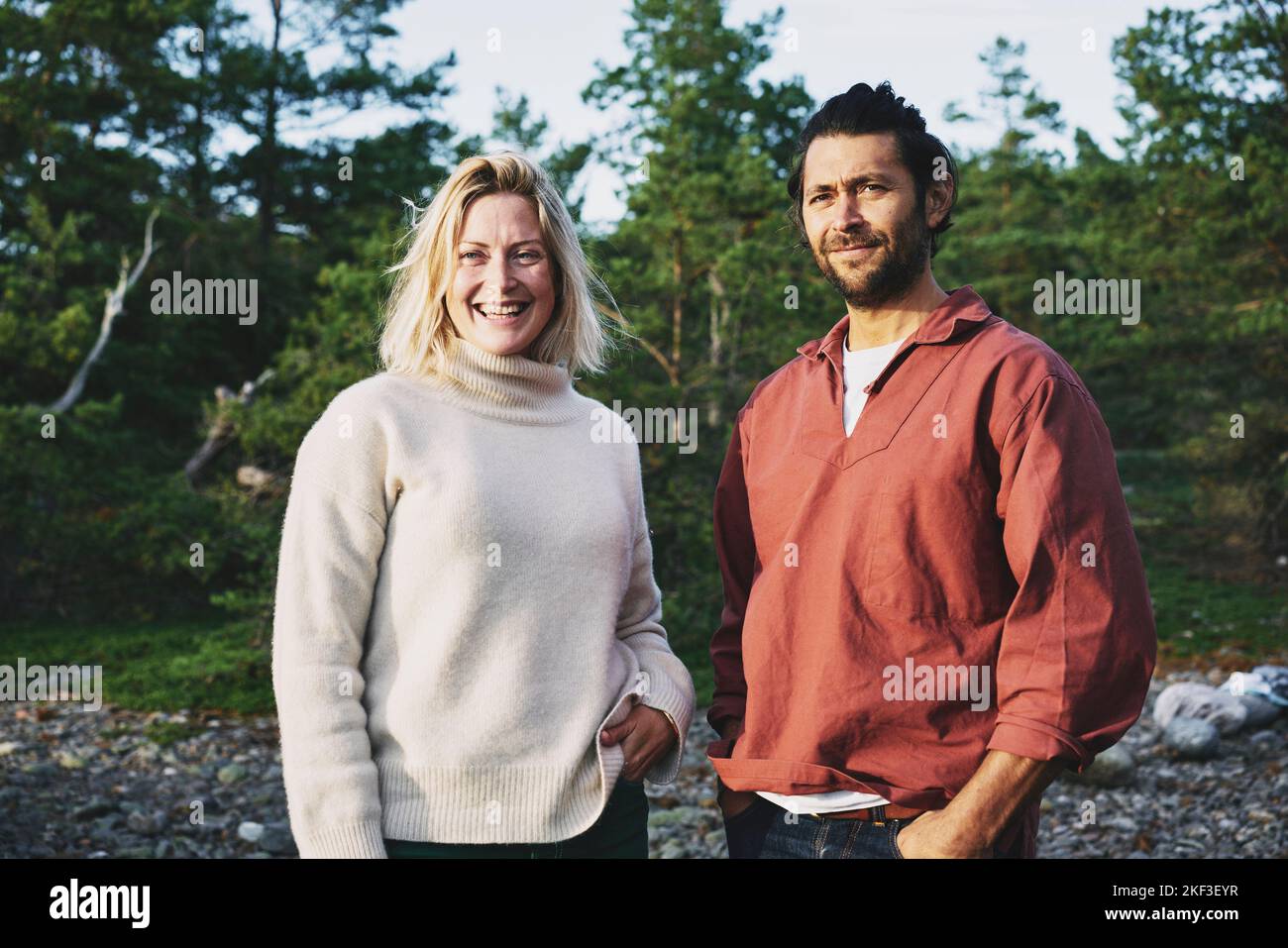Happy couple standing near forest Stock Photo