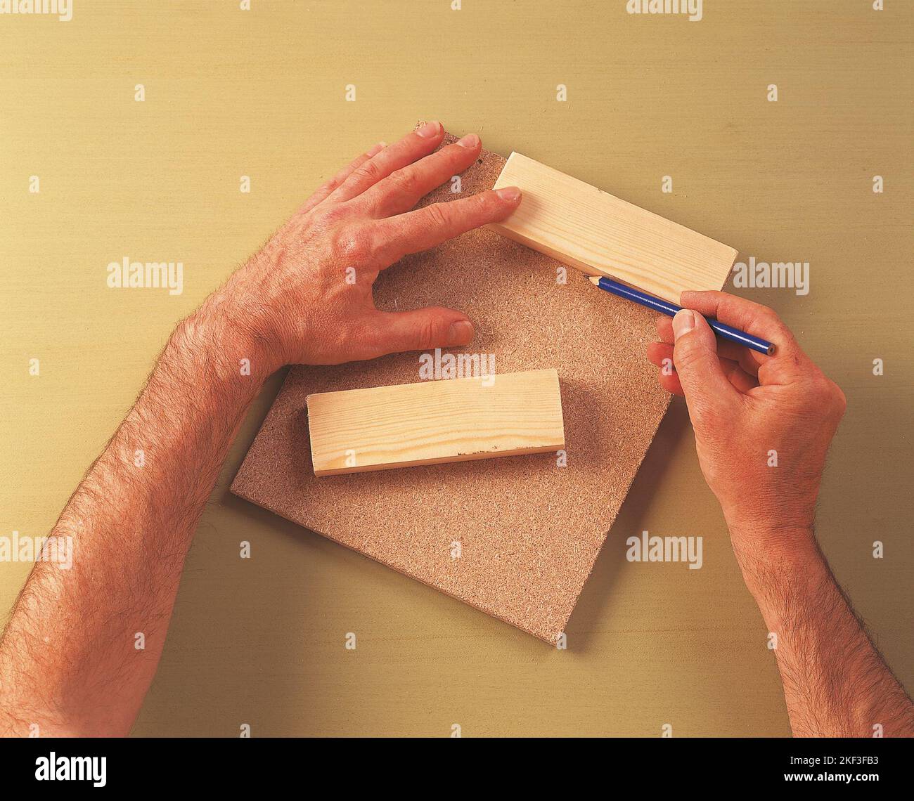 Marking position of a timber piece on the chipboard Stock Photo Alamy