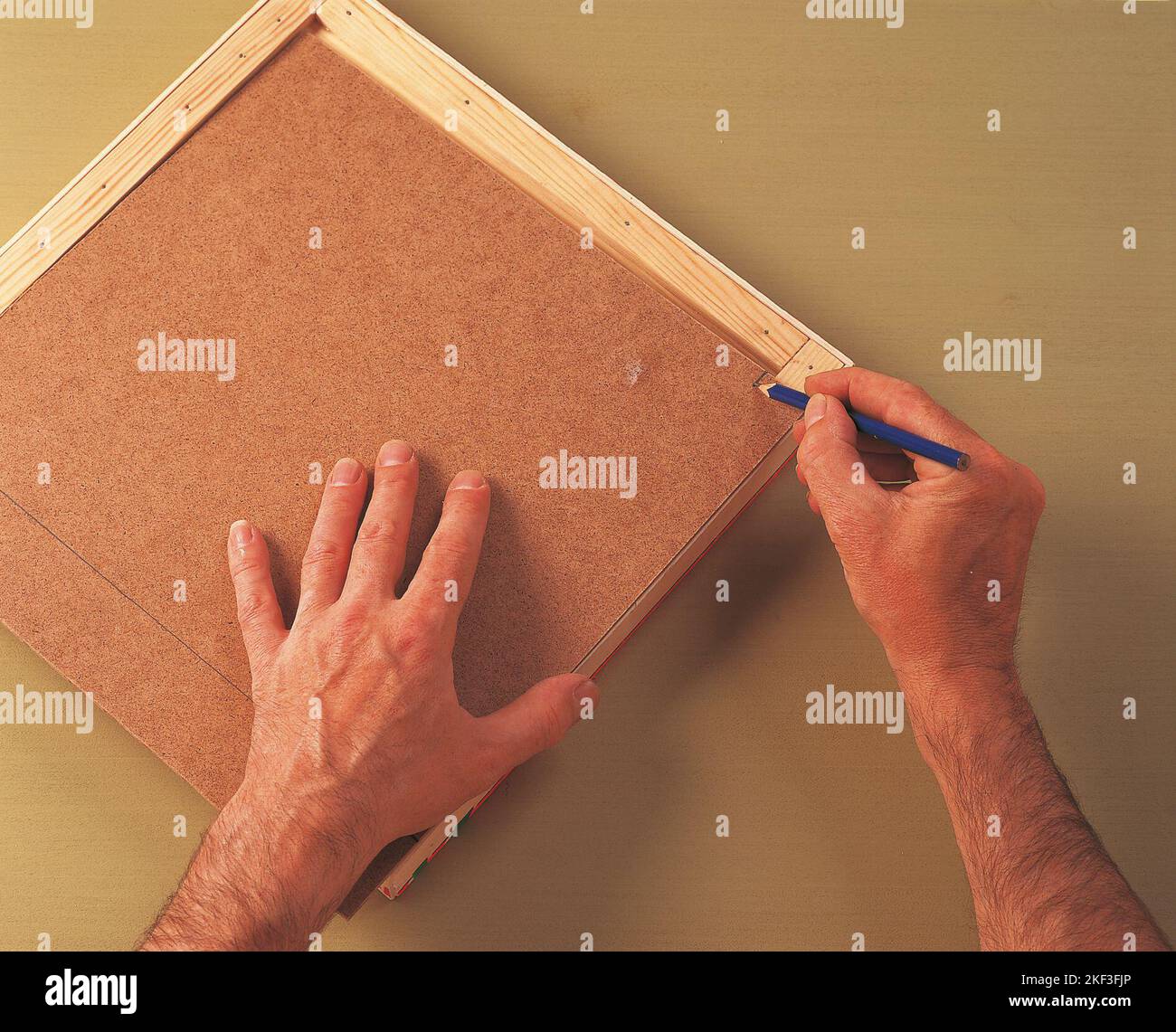 Marking the back of of the hardboard Stock Photo Alamy
