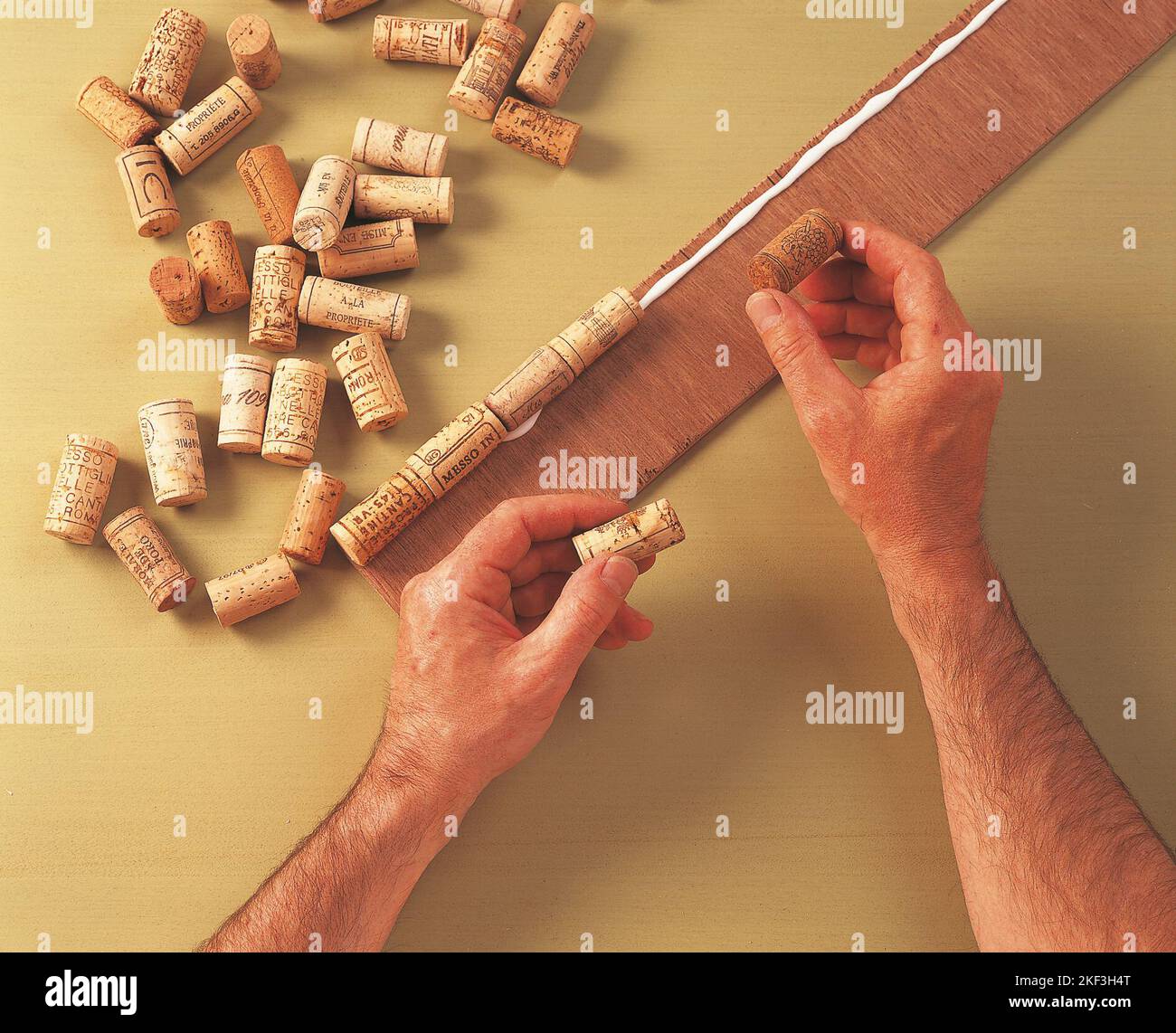 Attaching corks to the plywood Stock Photo Alamy