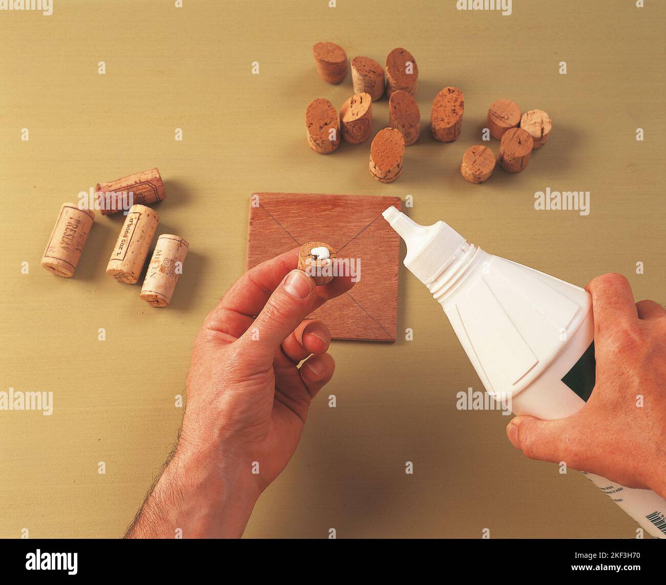 Applying glue to a cork half Stock Photo Alamy