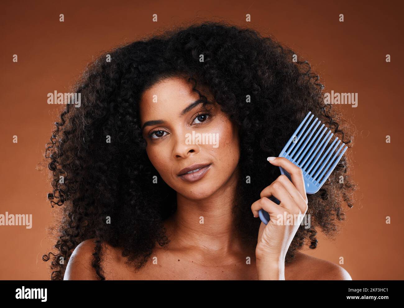Hair, comb and beauty with a black woman model in studio on a black