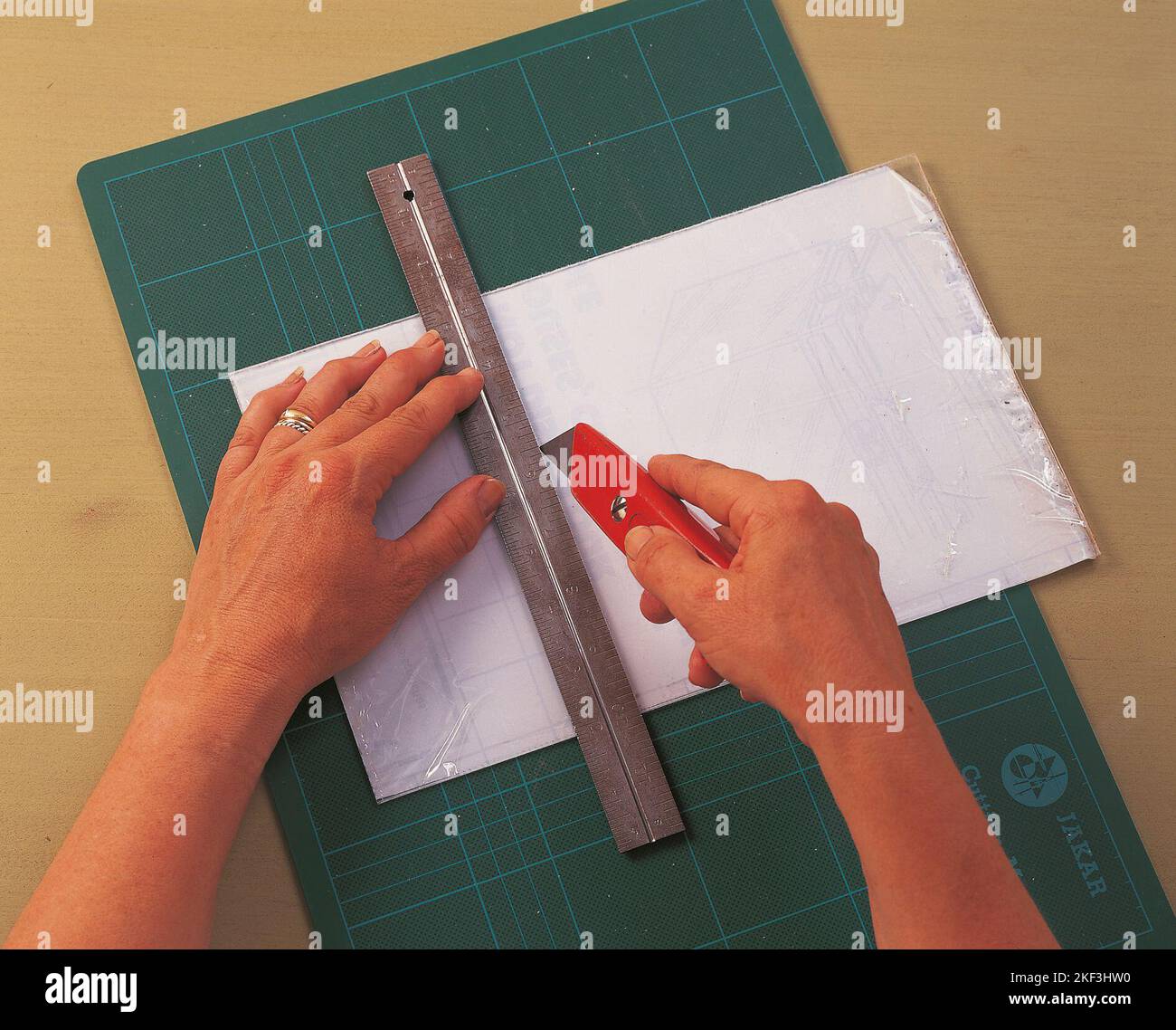 Cutting a sheet of perspex with utility knife Stock Photo Alamy