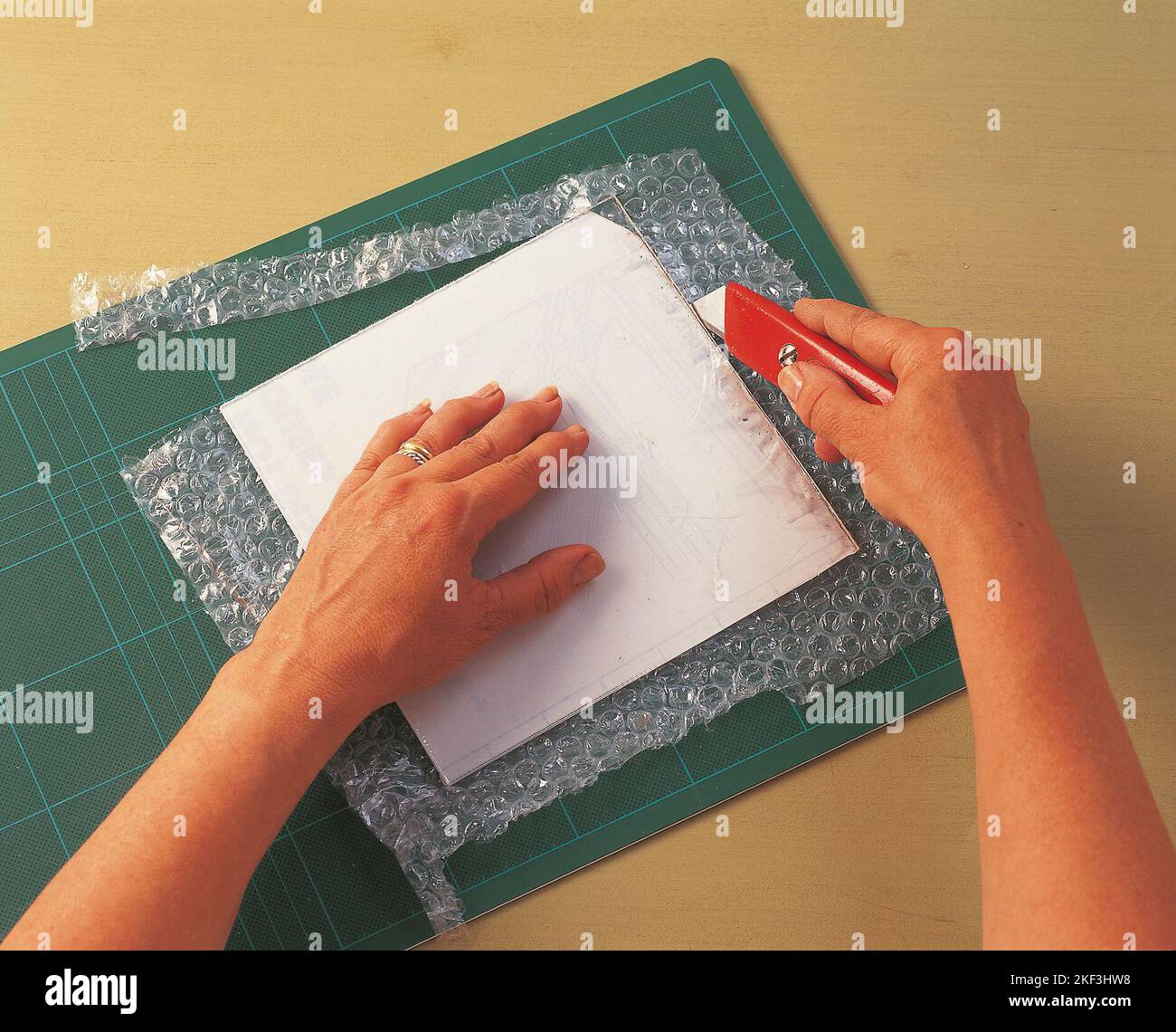 Cutting out a square of bubble wrap Stock Photo Alamy