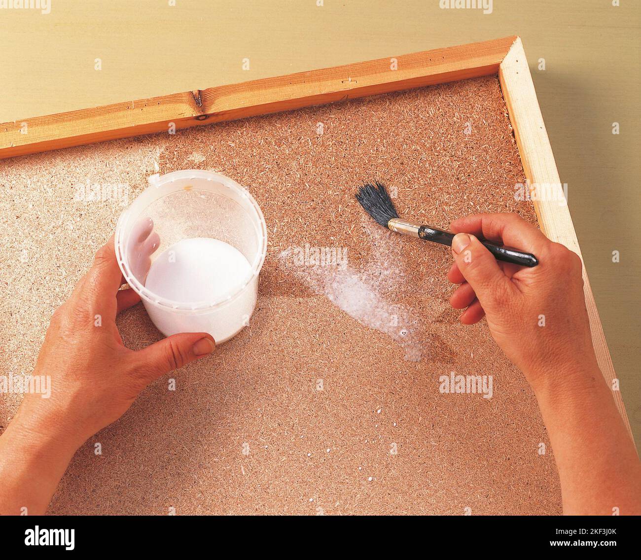 Painting the chipboard with white adhesive Stock Photo Alamy