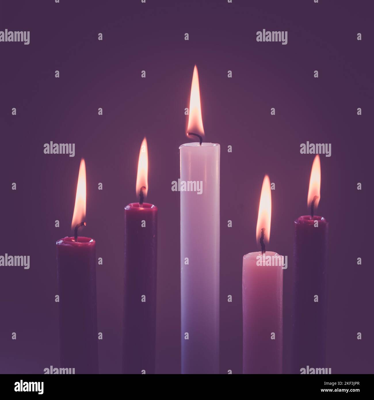 3 purple candles, 1 pink and one white candle burning, advent wreath