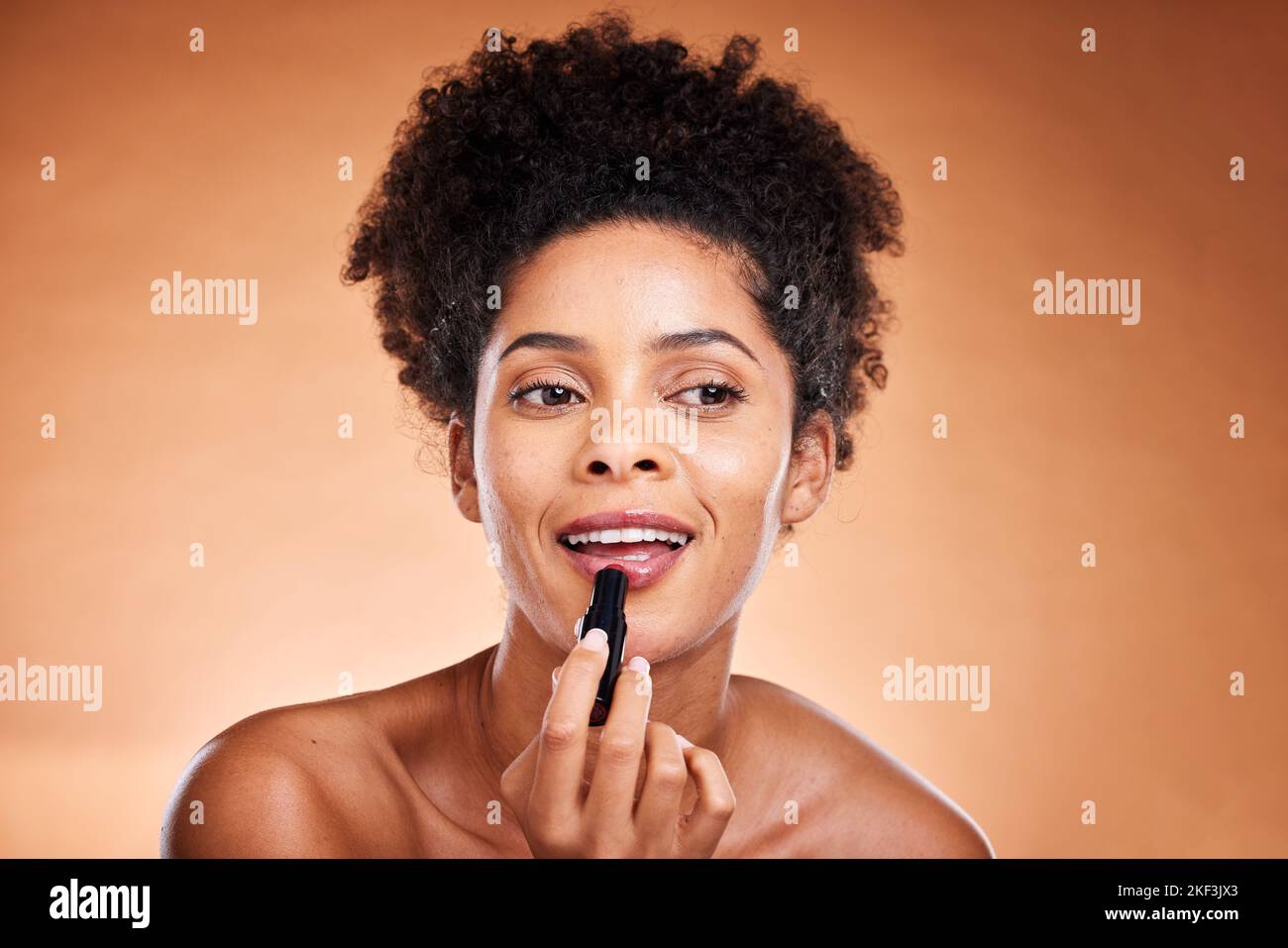 Black woman, afro and face glow lipstick on studio background for ...