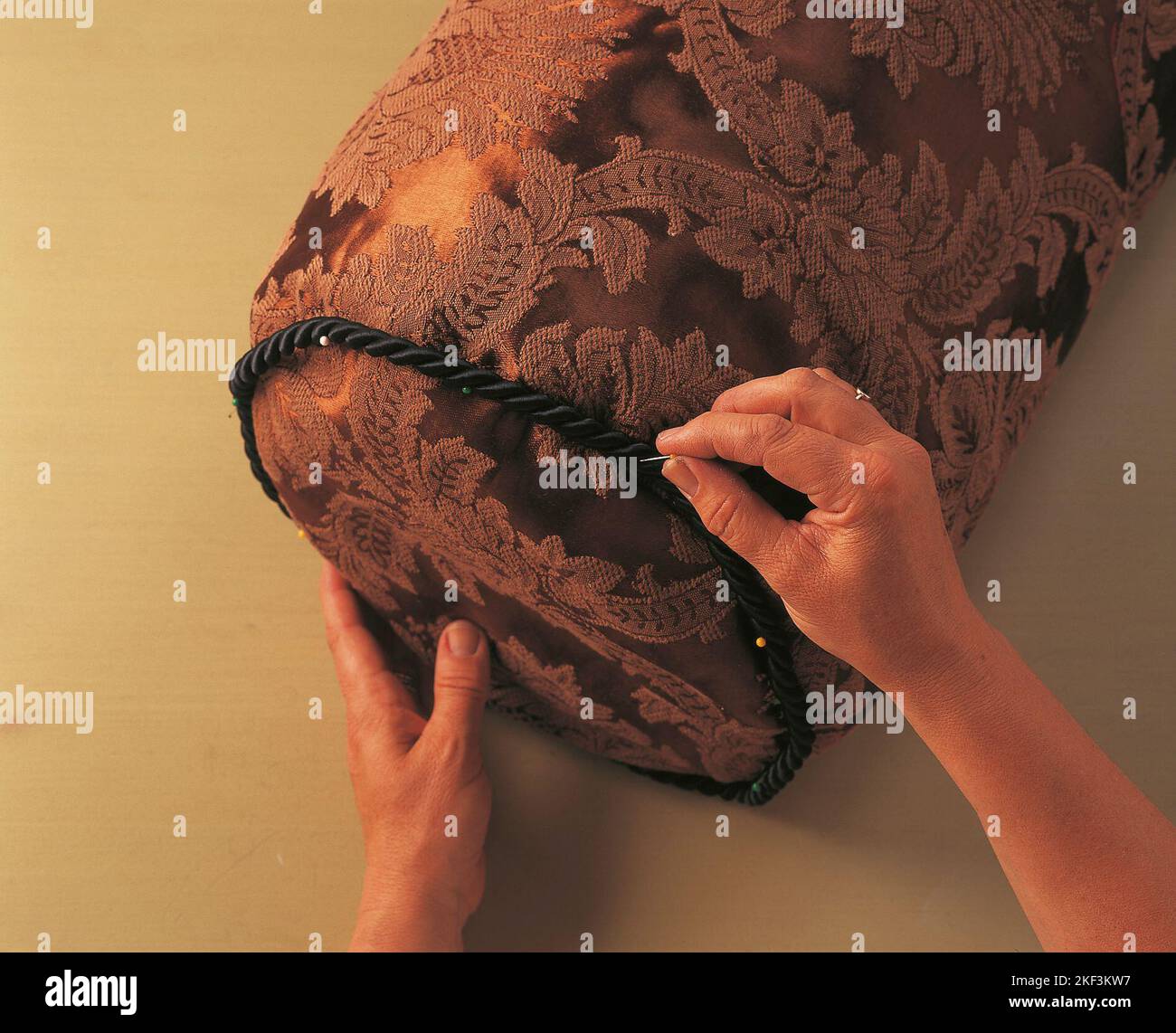 Hand-stitching a braid around the end seams Stock Photo - Alamy