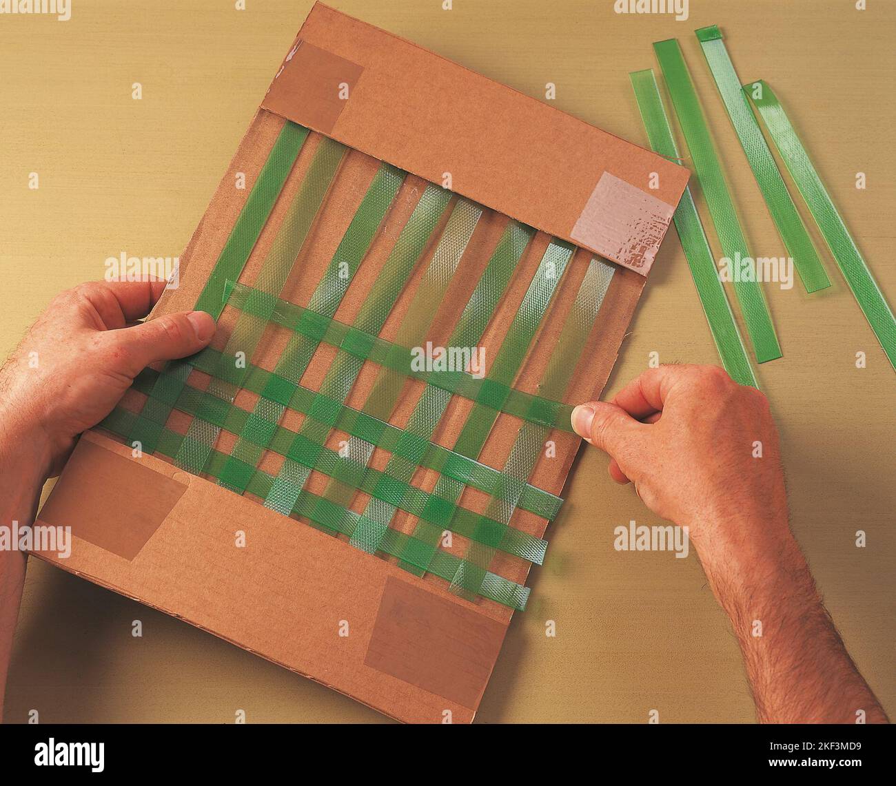 Weaving a plastic strip crossway Stock Photo Alamy