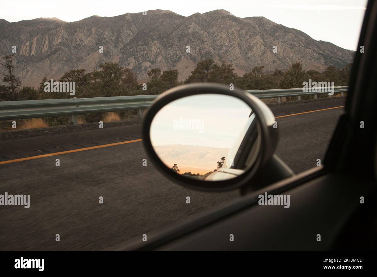 Wing mirror of car driving on highway Stock Photo Alamy