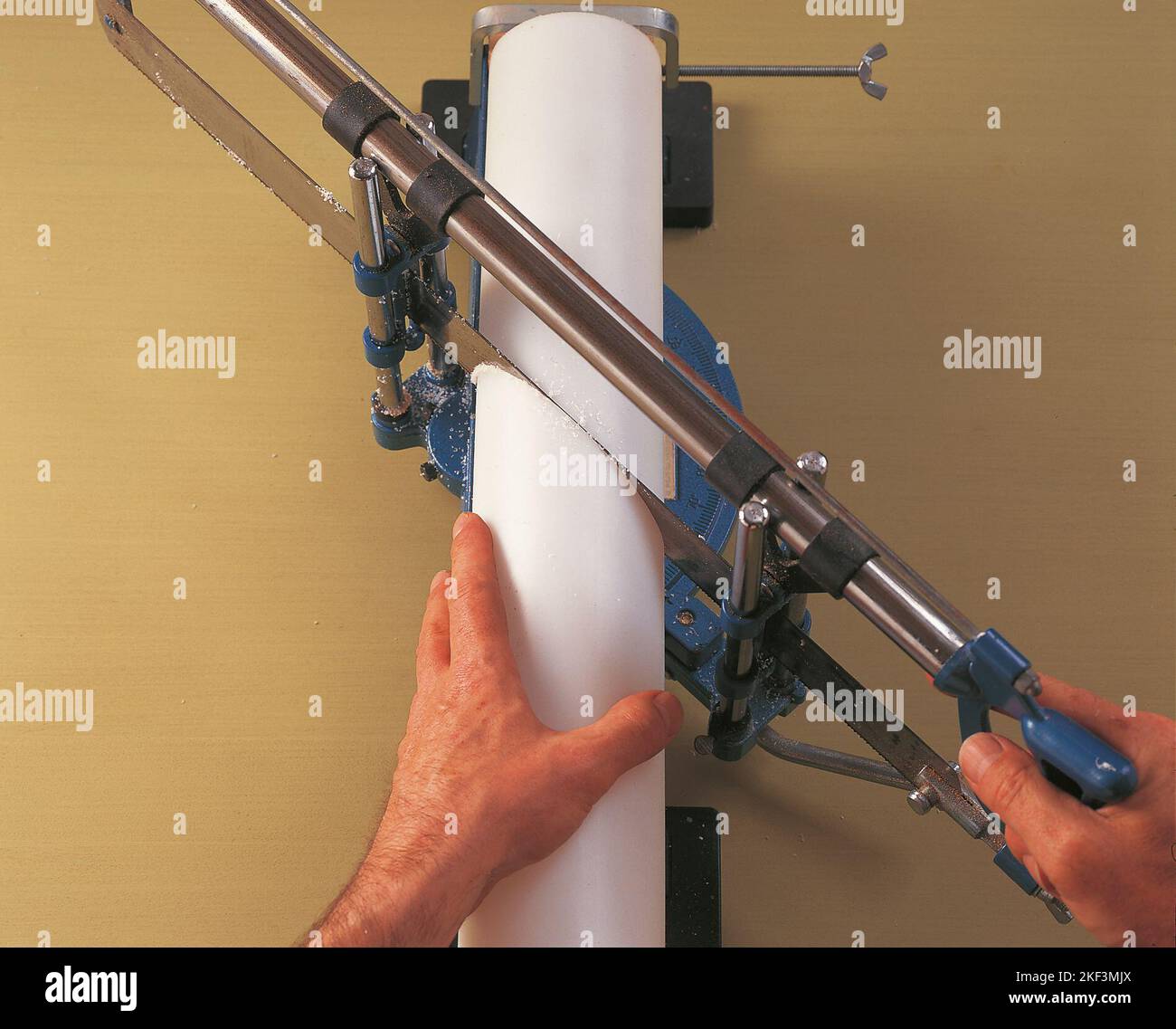 Cutting a plastic tube with a mitre saw Stock Photo Alamy