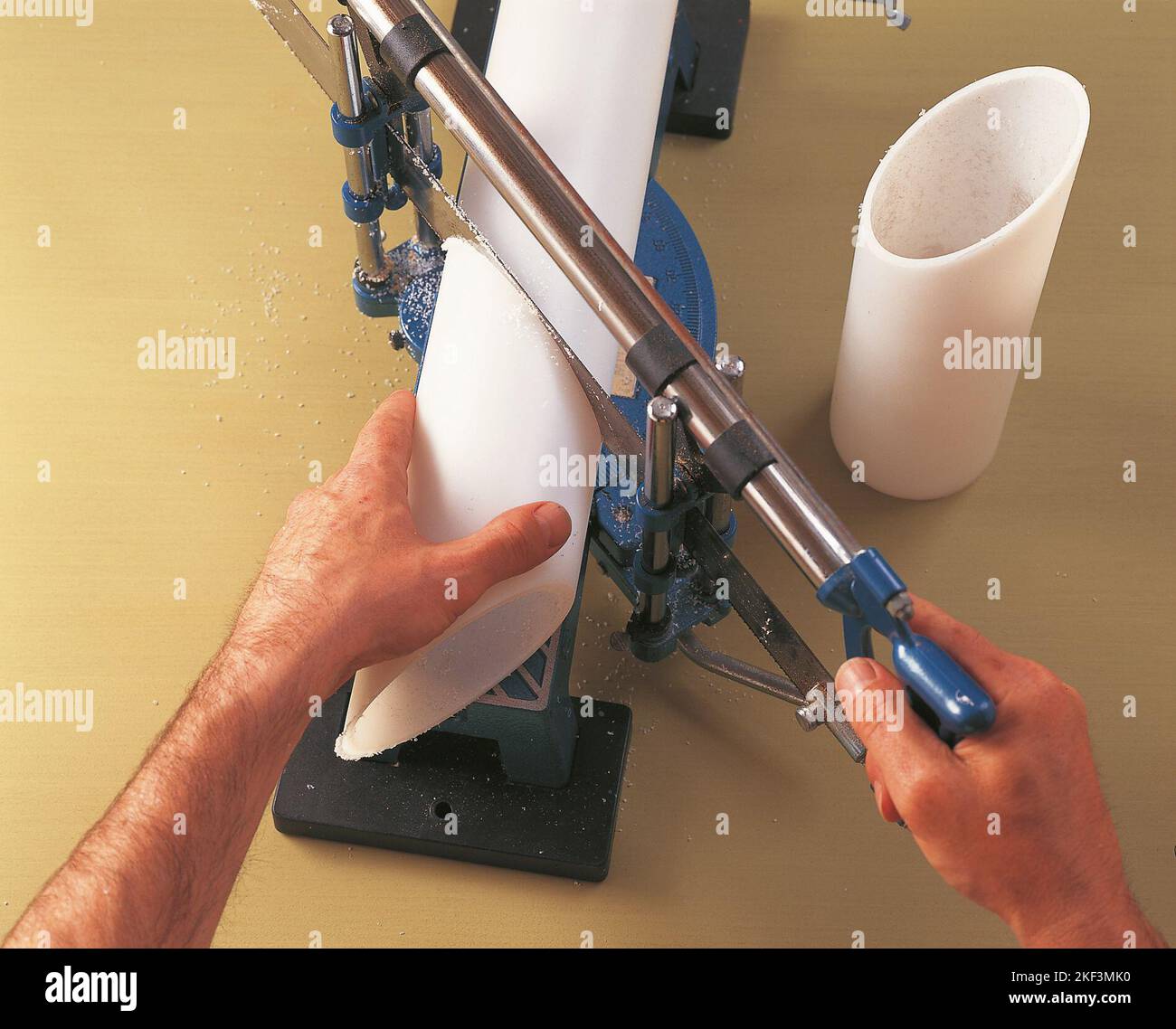 Cutting a plastic tube with a mitre saw Stock Photo Alamy