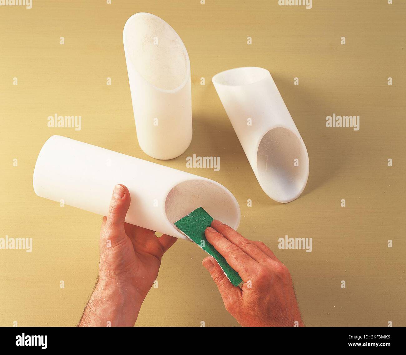 Removing rough bits with fine sandpaper Stock Photo Alamy