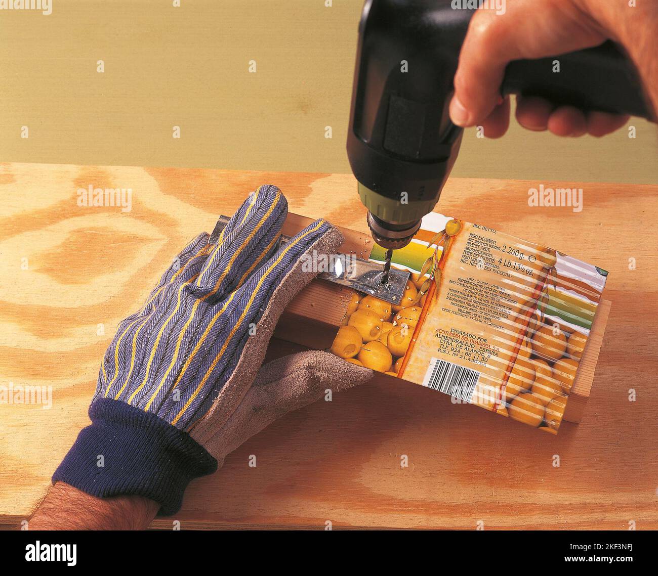Drilling through two pieces of tin Stock Photo Alamy