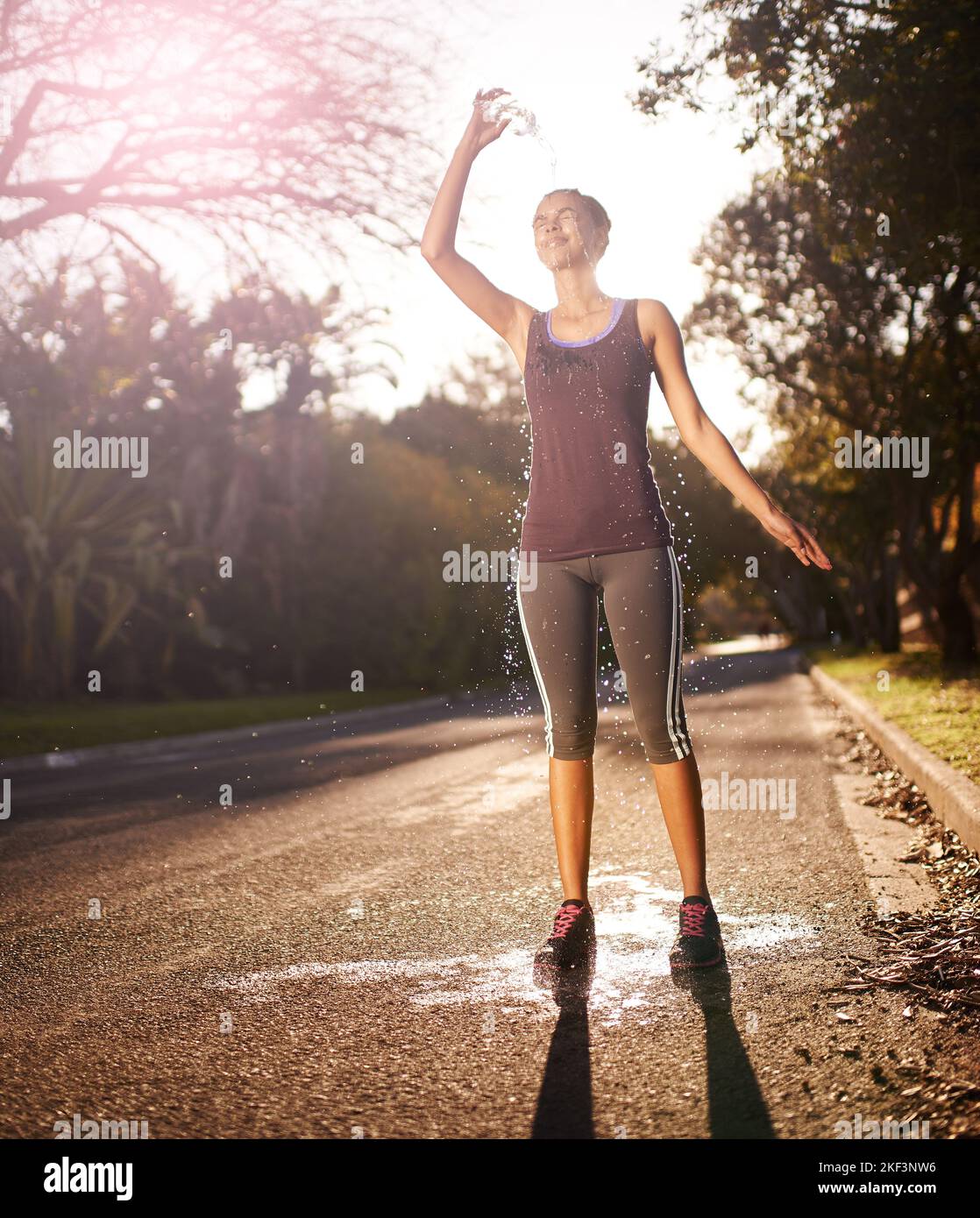 Now thats refreshing. a young woman pouring cold water over her head