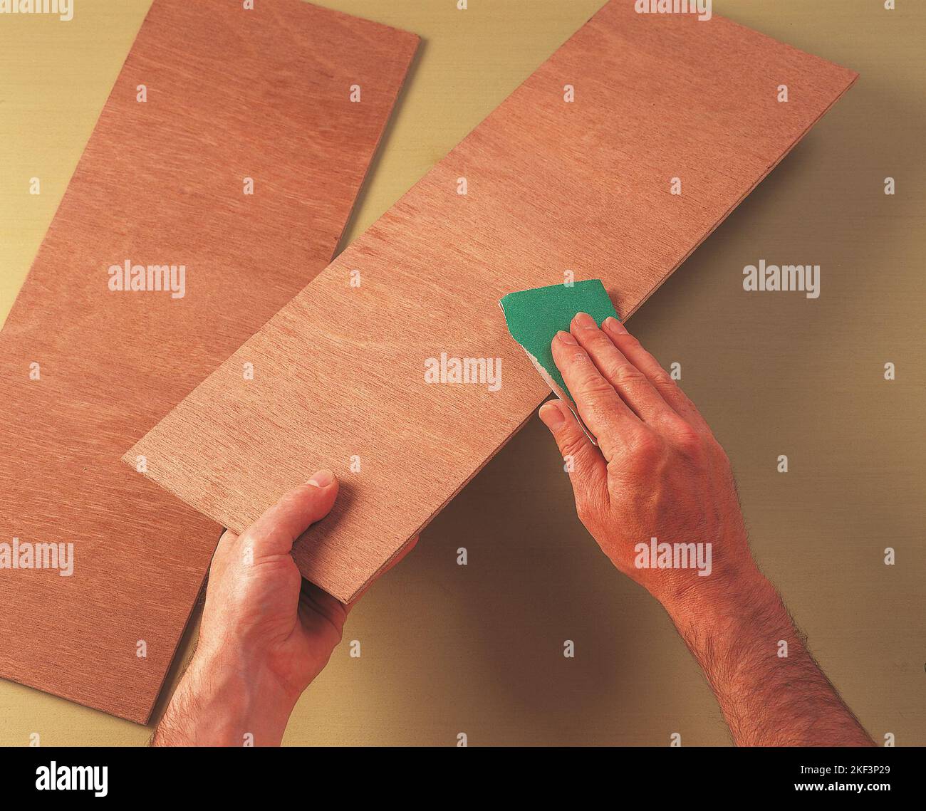 Sanding a piece of plywood Stock Photo Alamy