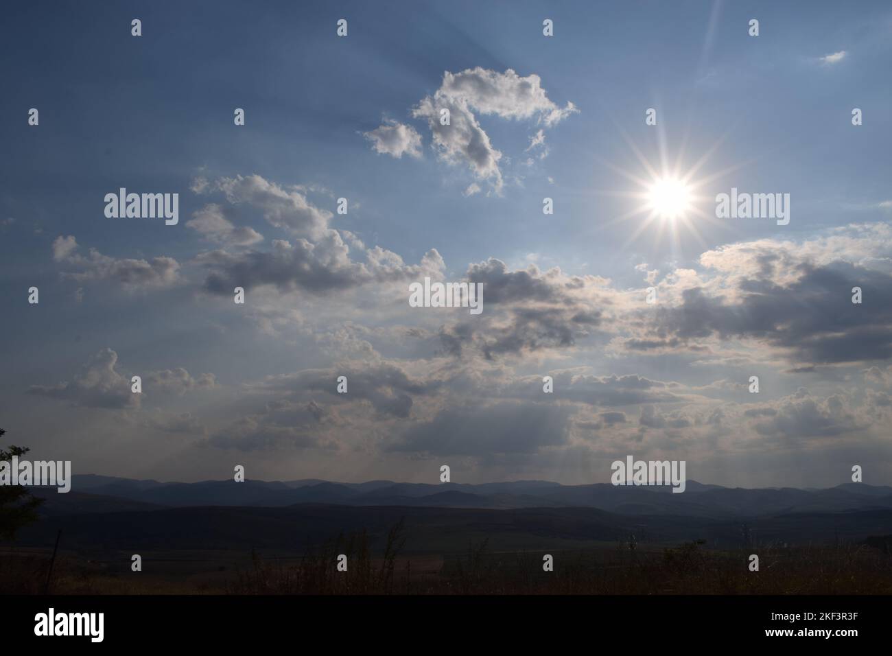 A photo surprising an amazing view near Cluj-Napoca, in which the sunrays are coming from behind the clouds. Stock Photo