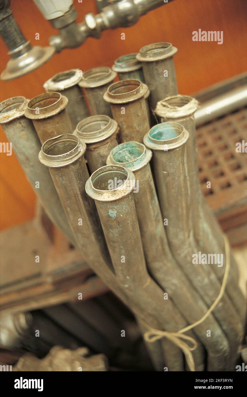 A bunch of old plumbing pipes tight together with a string Stock Photo
