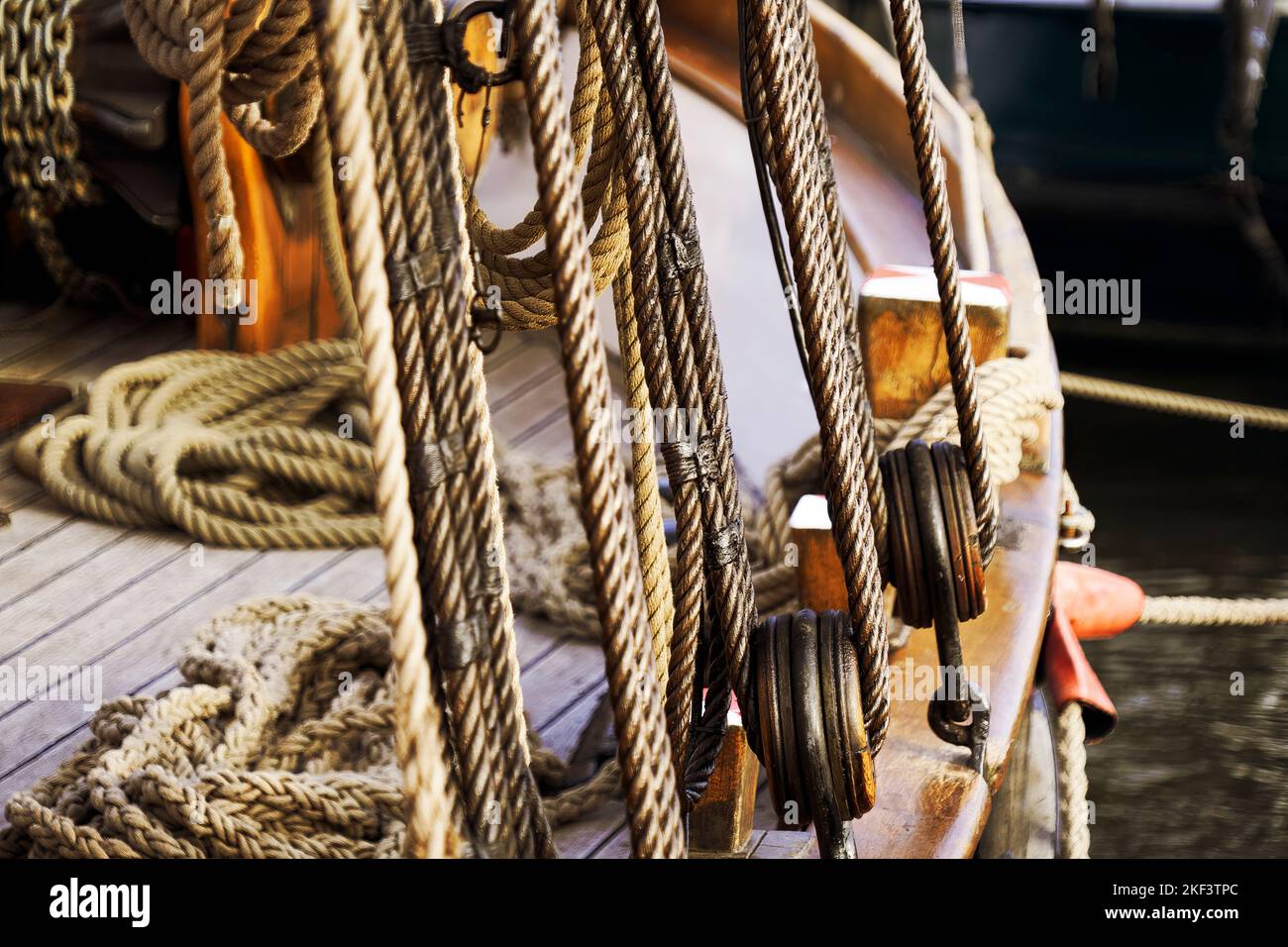 Rigging and rope pulleys on the wooden side of a sailing ship with