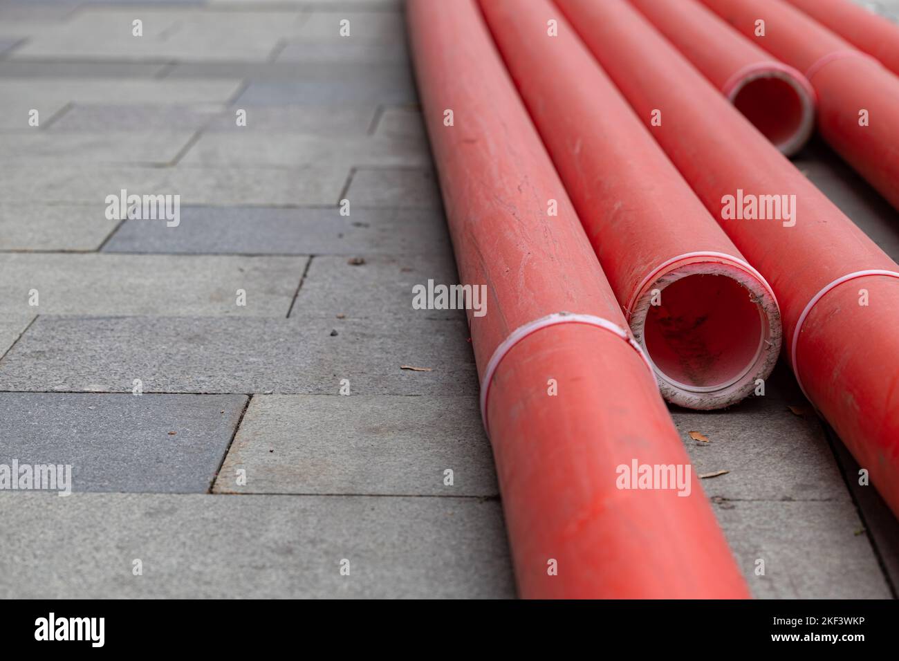 red plastic pipe lies on the ground. plastic pipe. High quality photo