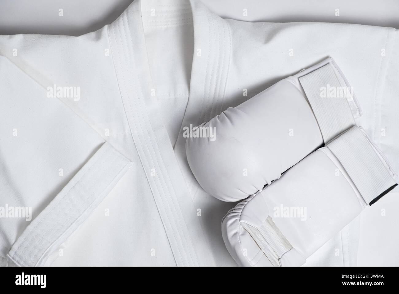 Kimono and white gloves for karate training for children, top view Stock Photo