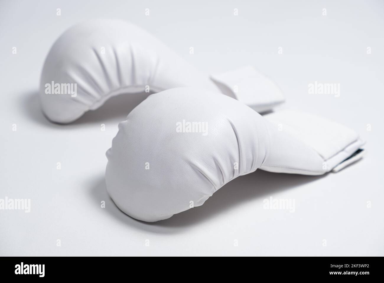 White boxing gloves for a child to practice karate or other martial