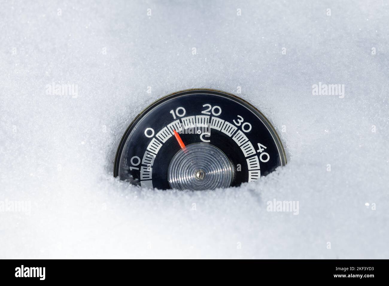 Thermometer with celsius scale placed in a fresh snow showing subzero