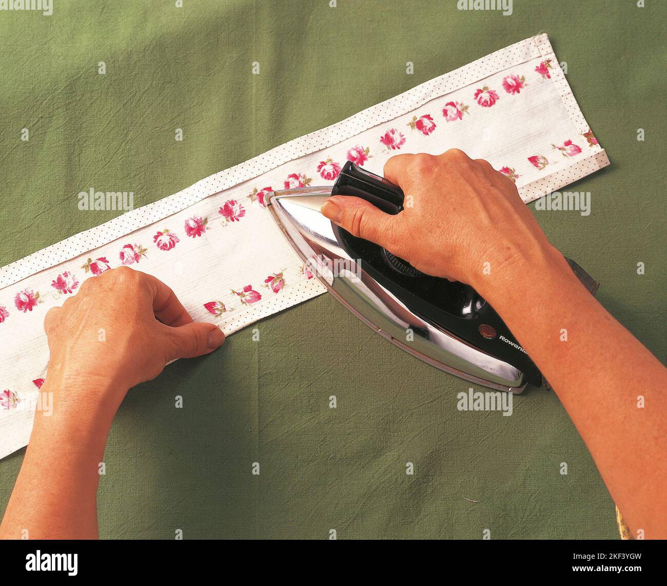 Ironing a piece of fabric Stock Photo Alamy