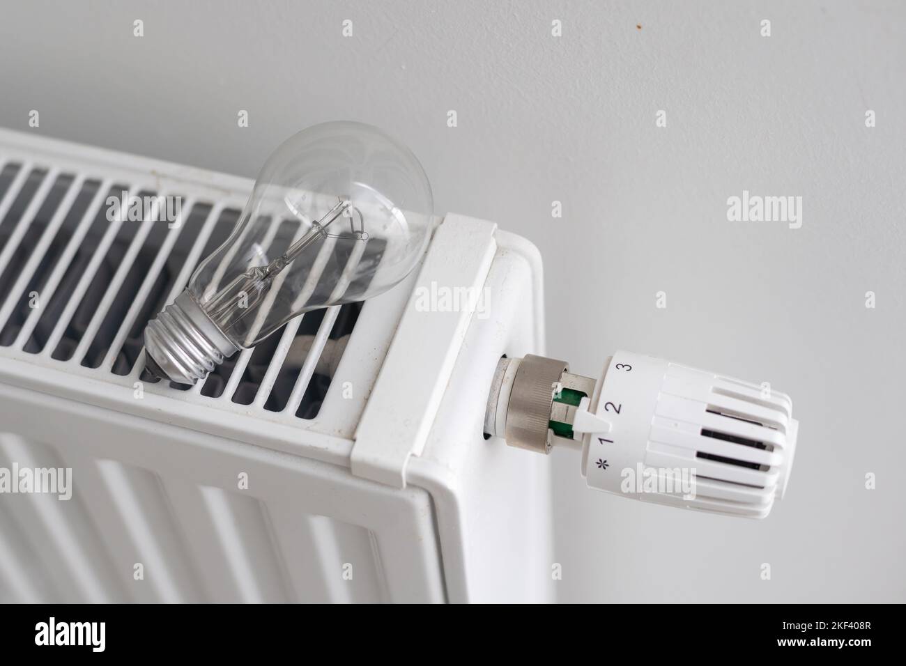 Lights Behind Radiator Energy crisis. light bulb on a radiator. electric and gas. Central ...