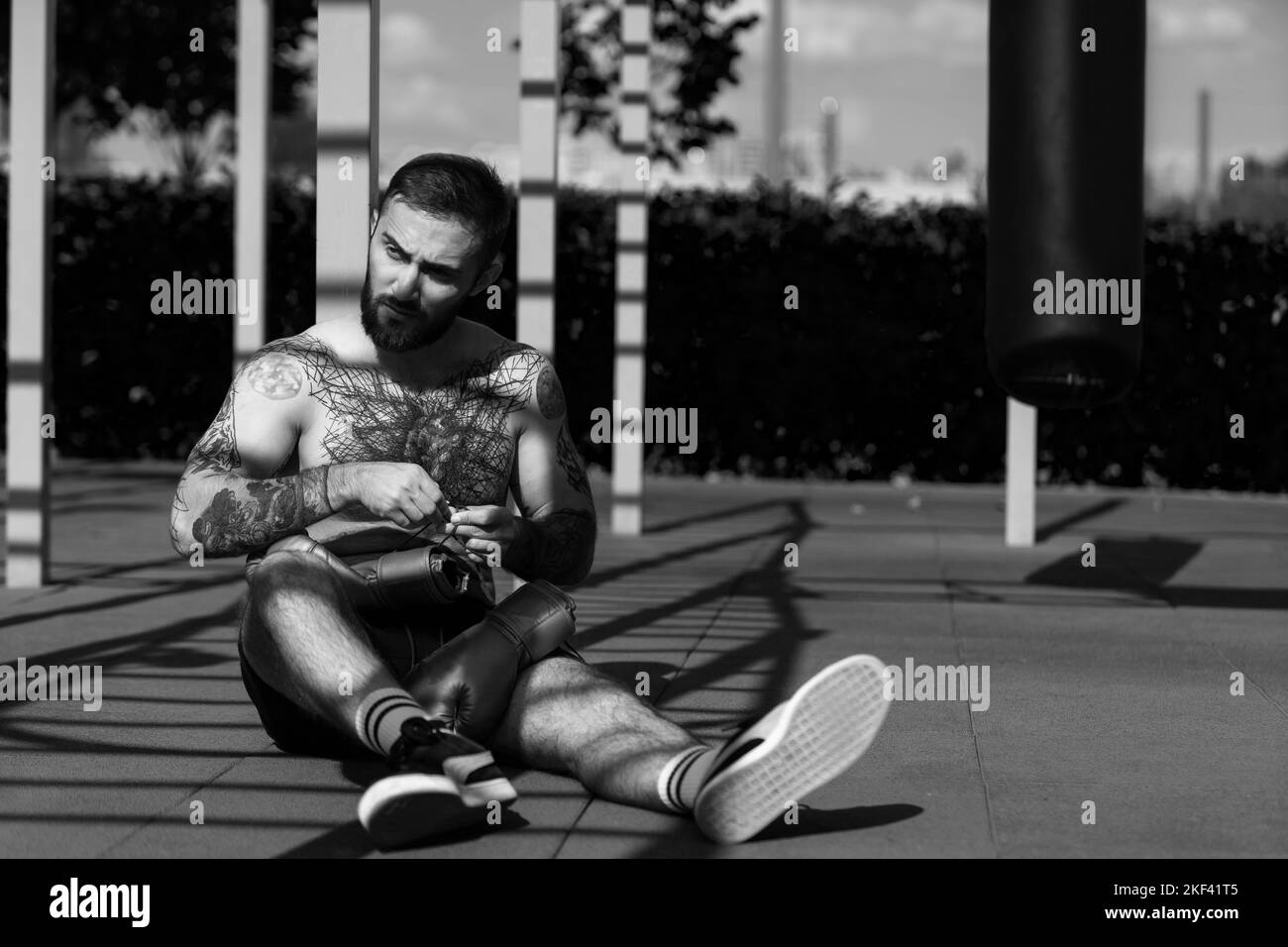 a man trains on the street with exercise machines Stock Photo