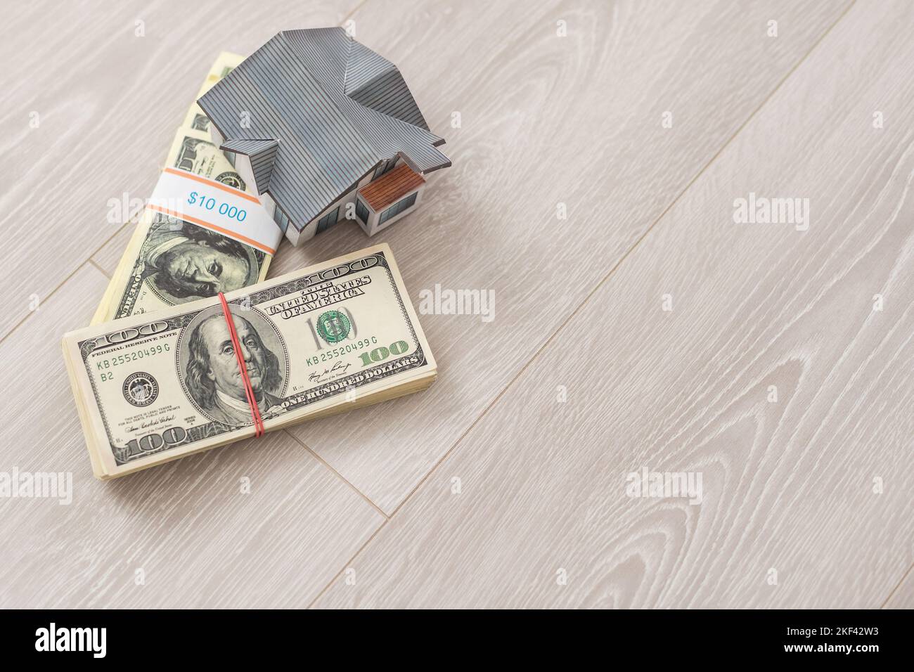 A toy house made of wood with a roof costs money, on a hundreddollar