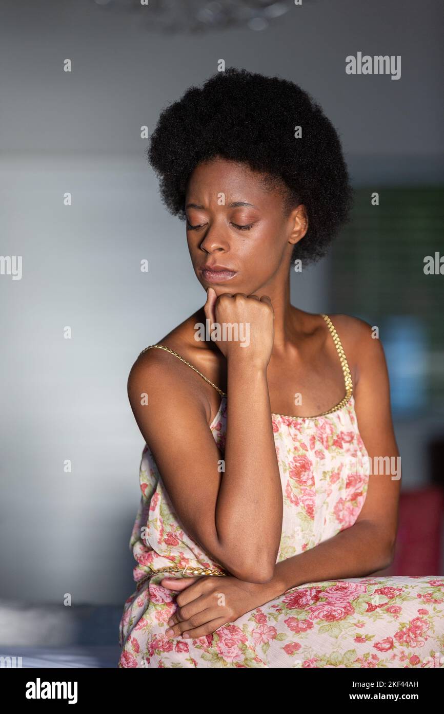 Woman wearing black dress sitting hi-res stock photography and images ...