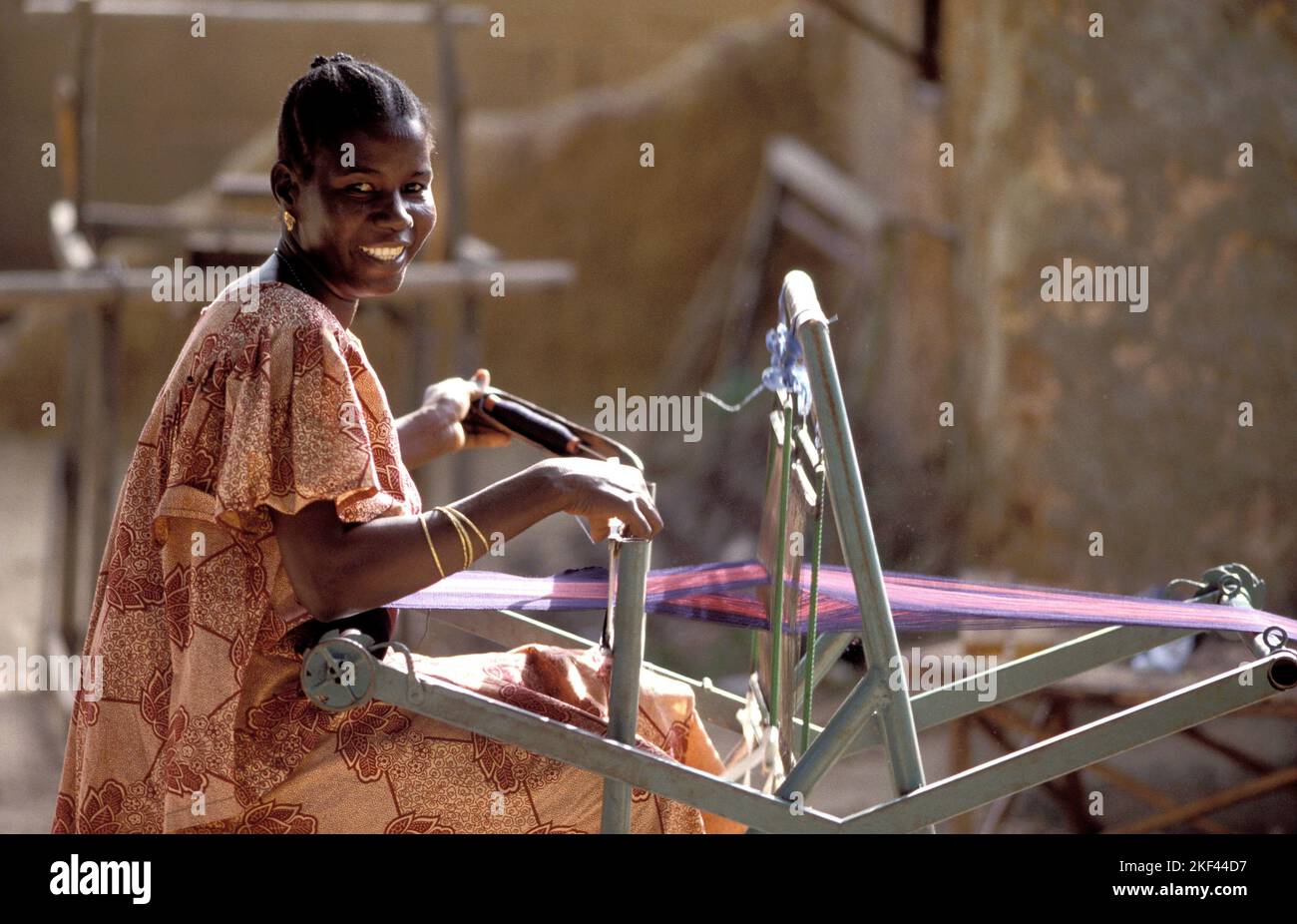 Burkina Faso, Fada; Woman is weaving with a loom. Stock Photo