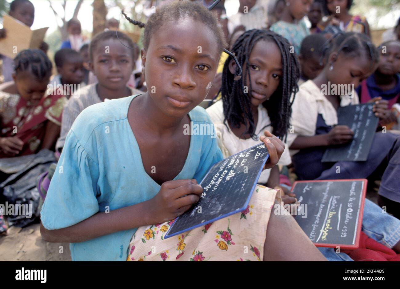 Burkina Faso, Fada. School children are writing on slates. Stock Photo