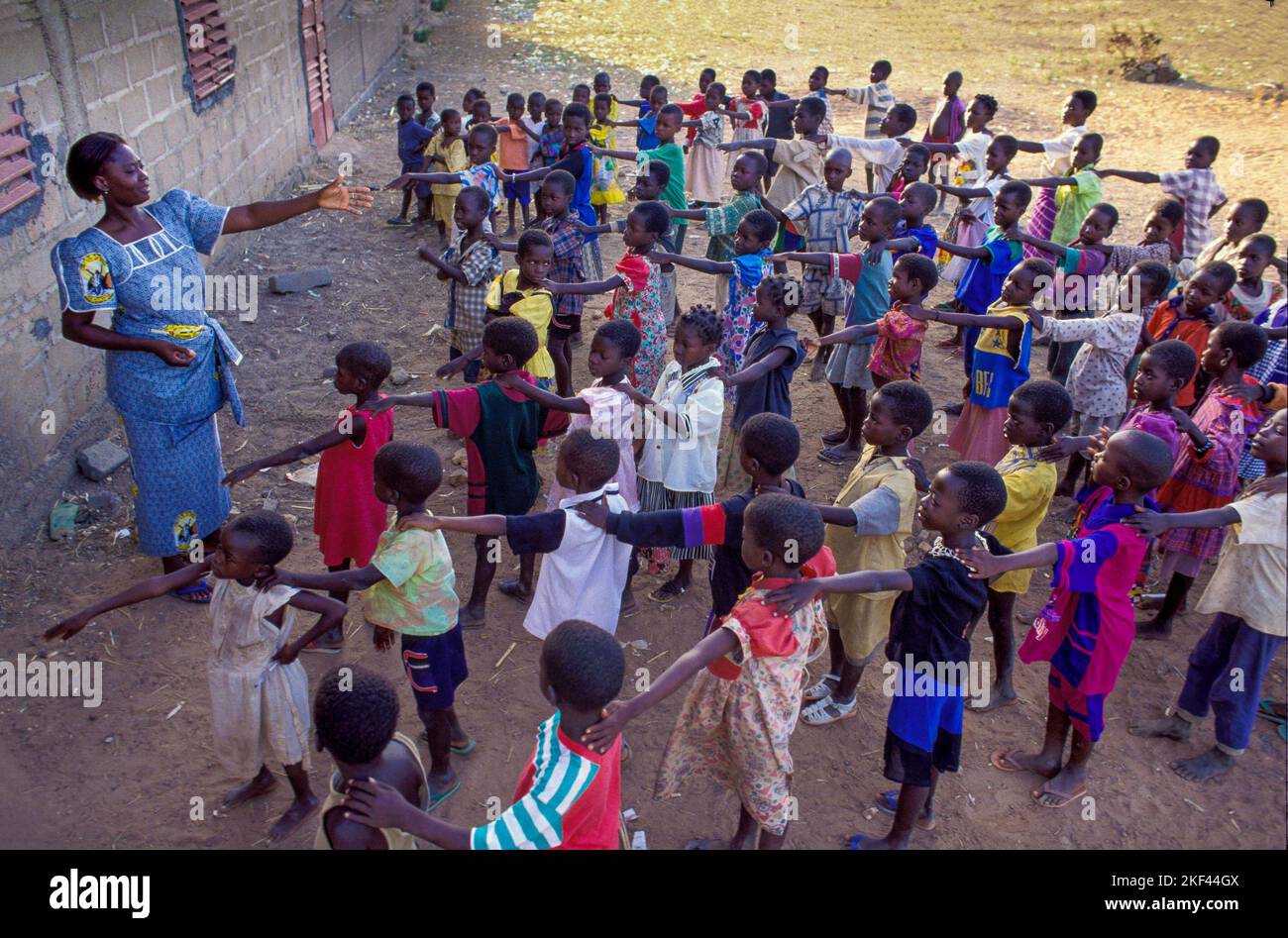Burkina Faso, Fada region, A teacher at a primary school with her class in the open air. Stock Photo