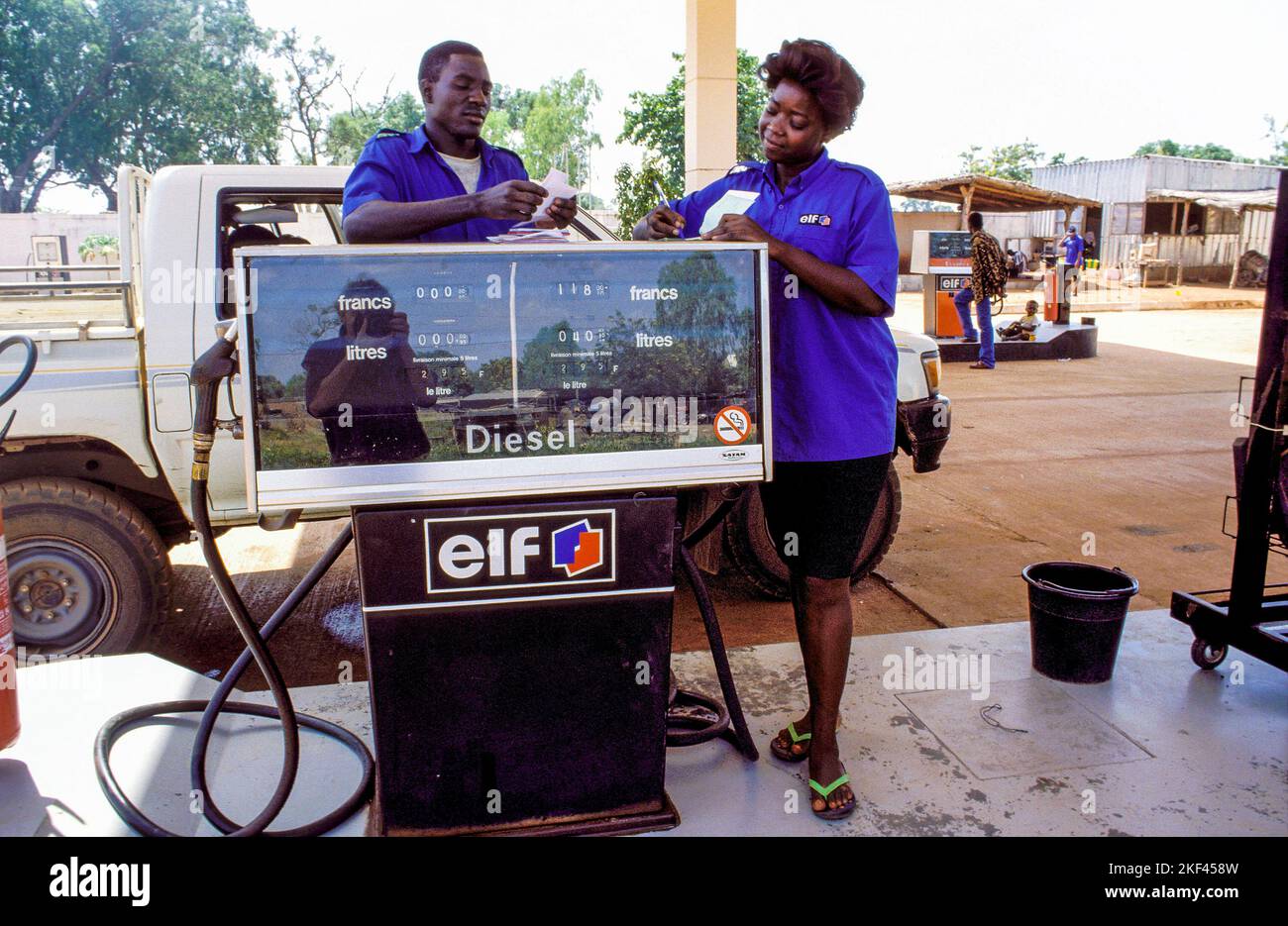 Burkina Faso, Fada Employees of a gazoline station checking the bills. Stock Photo
