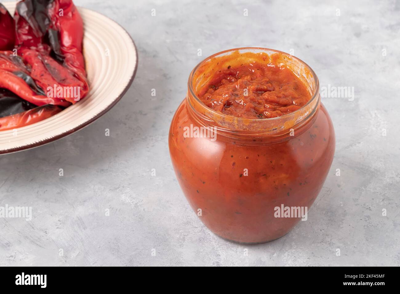 Glass jar of delicious Ljutenica made of roasted bell peppers on