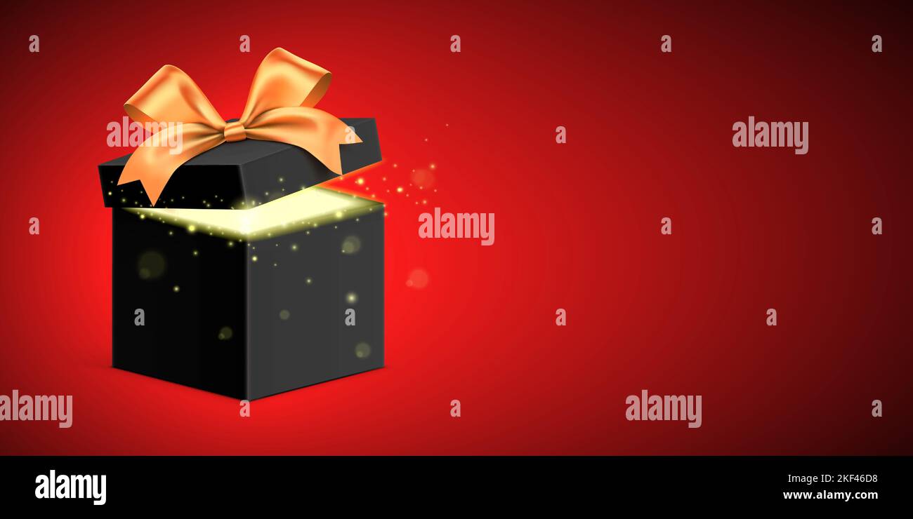 Black gift box with golden ribbon and glitter light shining from inside