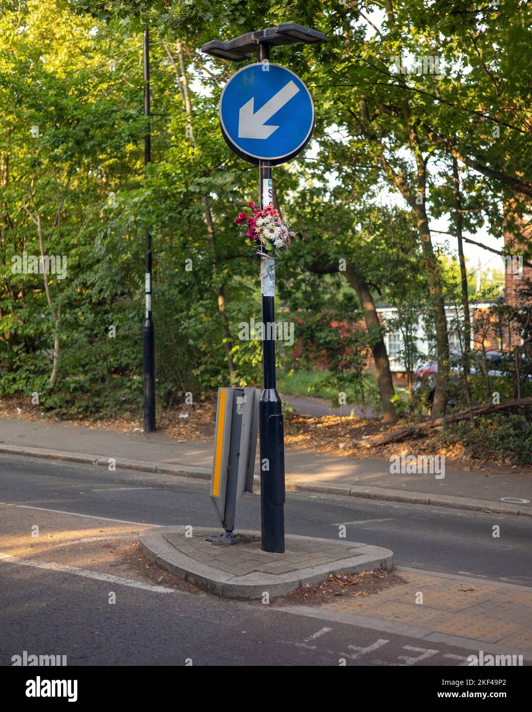 road traffic sign with memorial flowers Stock Photo