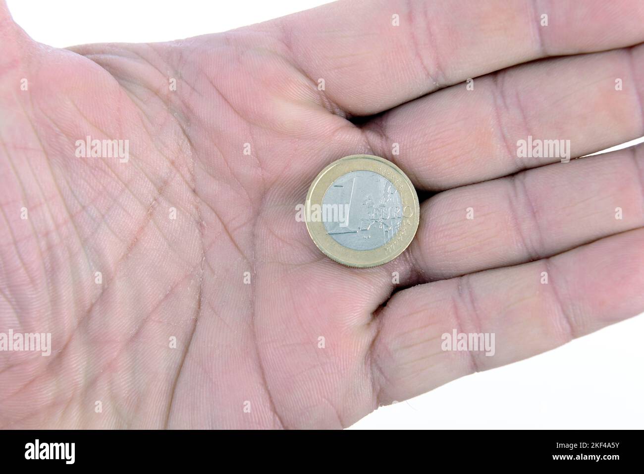 Münze, ein Euro in einer Hand Stock Photo
