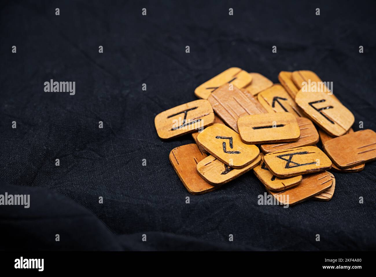 Handmade wooden runes on black fabric. Heap of Scandinavian runes for ...