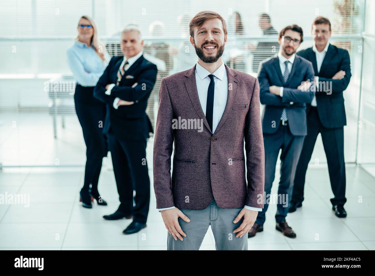 smiling business man standing in front of the business team Stock Photo ...