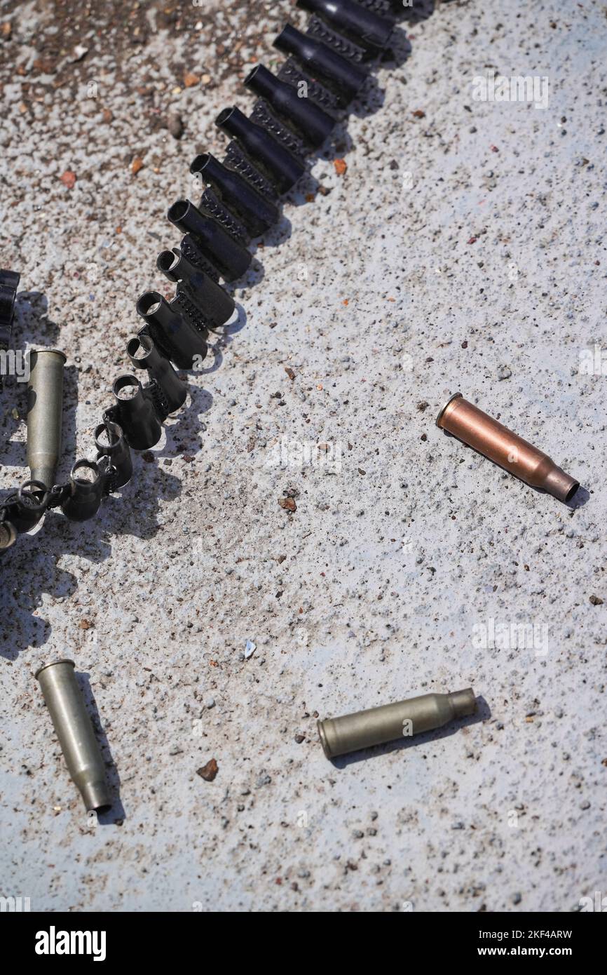 Machine gun empty bullet cartridges lay on the ground after being fired