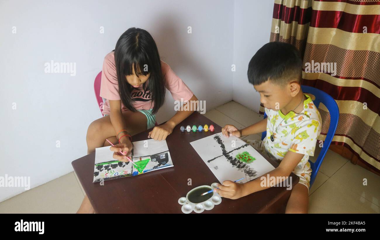 brothers and sisters painting with watercolors Stock Photo - Alamy