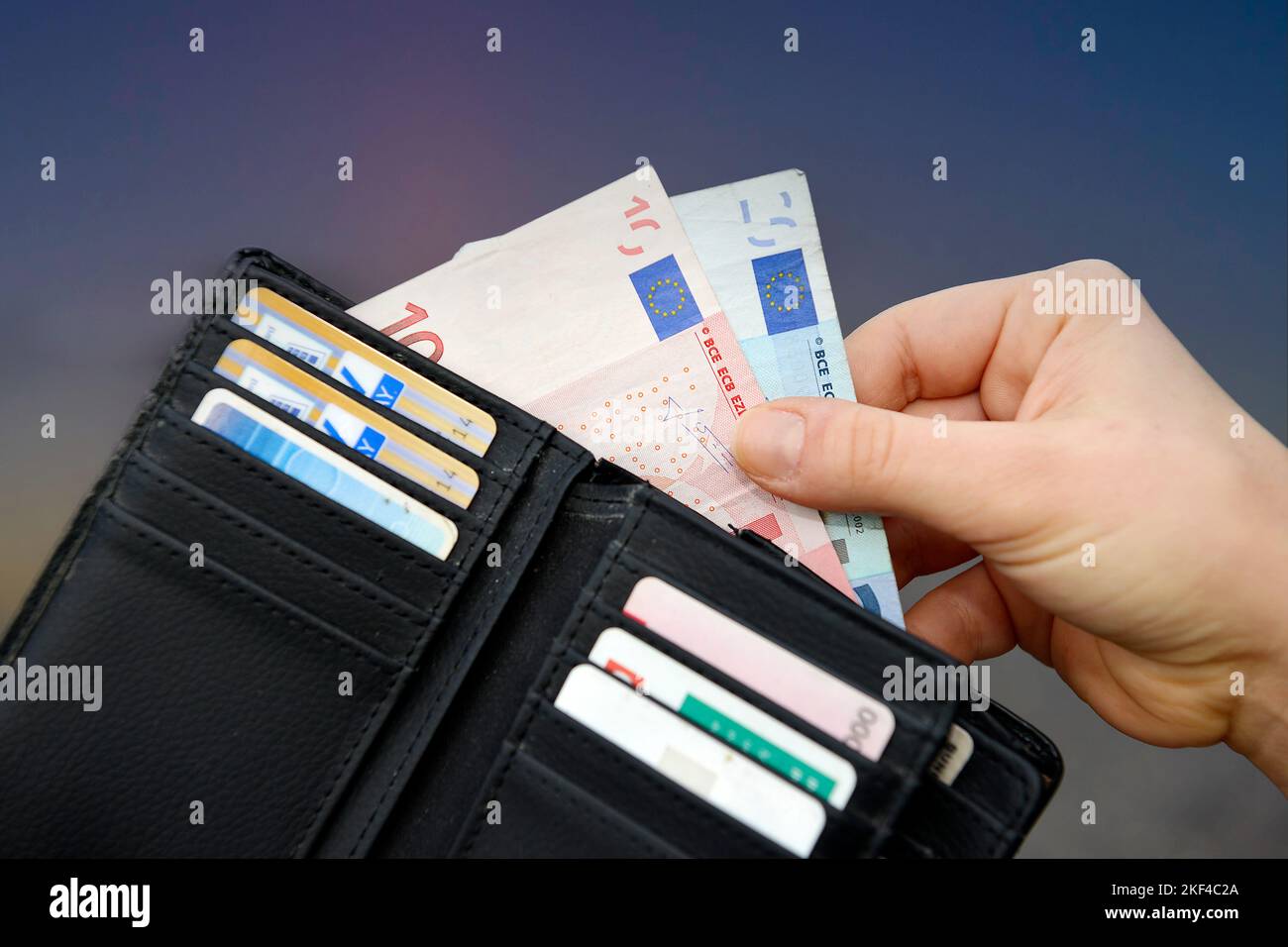 Eine Hand zieht Euro-Geldscheine aus Geldbeutel, Preissteigerung, Teuerungsrate, Hartz IV, Rente, Grundeinkommen, Bürgergeld, Grundrente, Stock Photo