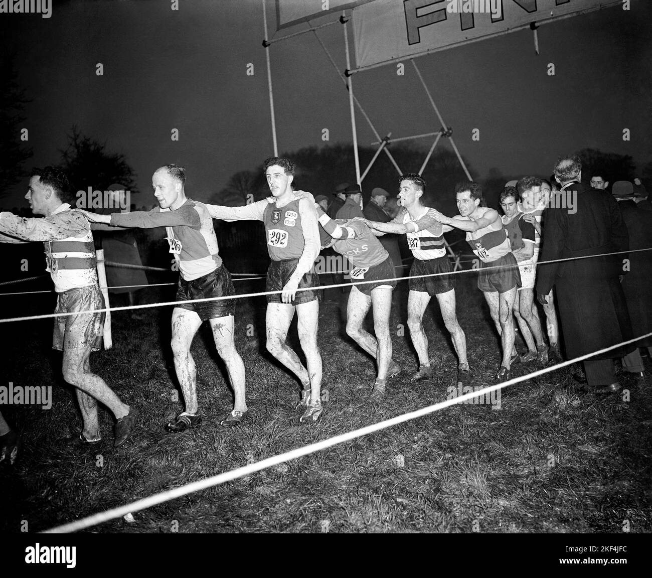 Exhausted competitors file through rope lanes as they finish the ...