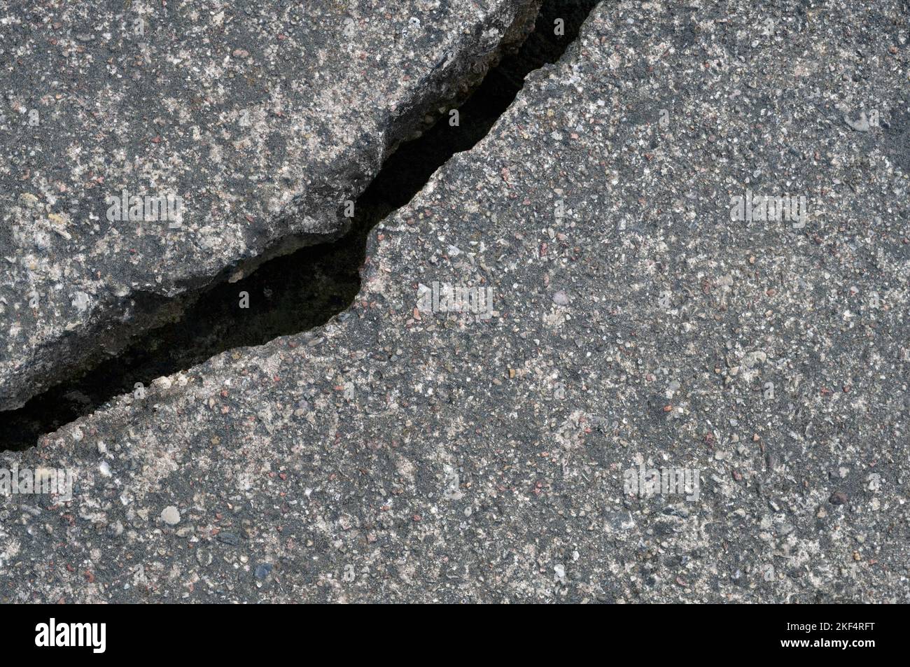 Old aged weathered cracked grey black tarmac texture pattern, large detailed damaged textured asphalt grungy background flat lay, horizontal rough Stock Photo