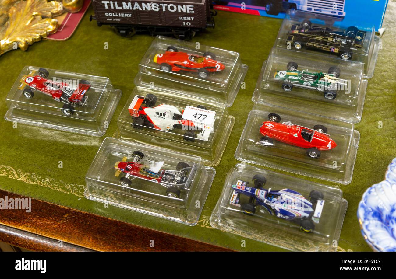 Boxed model racing cars in clear plastic boxes on display in auction room, UK Stock Photo