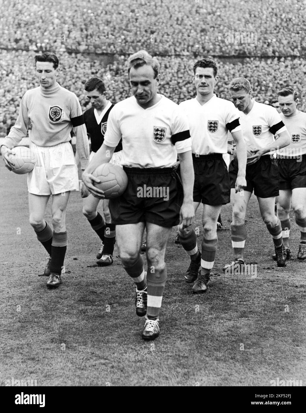 England captain Billy Wright (c) leads his team out, followed by