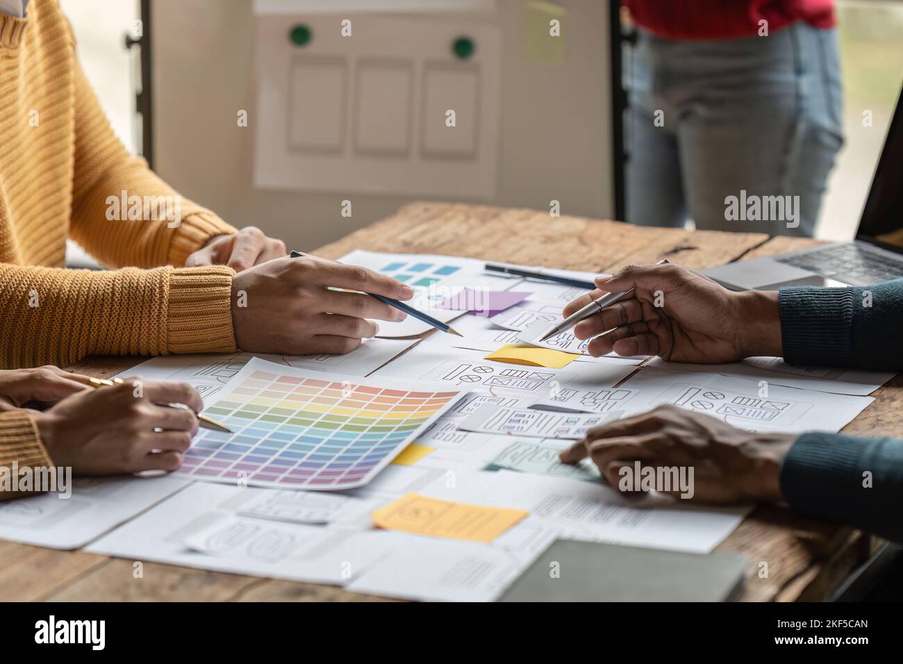 Group of ux developer and ui designer brainstorming about app interface design at modern office. Creative digital development agency Stock Photo